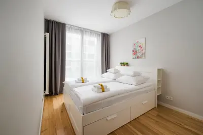Łóżko lub łóżka w pokoju w obiekcie ApartHotel Warsaw Center