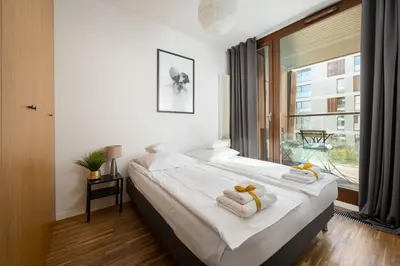 Łóżko lub łóżka w pokoju w obiekcie ApartHotel Warsaw Center