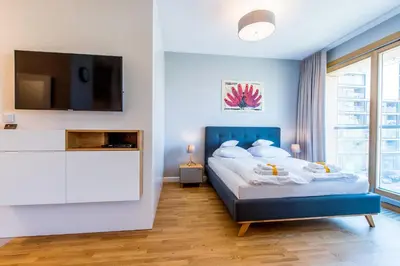 Łóżko lub łóżka w pokoju w obiekcie ApartHotel Warsaw Center