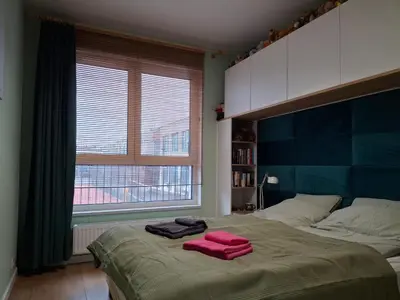 Łóżko lub łóżka w pokoju w obiekcie Heron Apartment