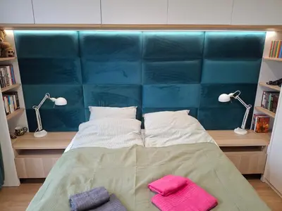 Łóżko lub łóżka w pokoju w obiekcie Heron Apartment