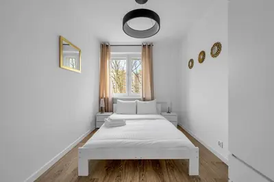 Łóżko lub łóżka w pokoju w obiekcie Mokotów Modzelewskiego Modern Apartment by BookingHost