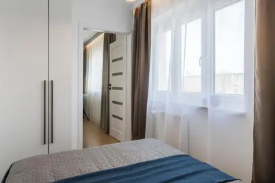 Łóżko lub łóżka w pokoju w obiekcie Nowolipie Blue Apartament