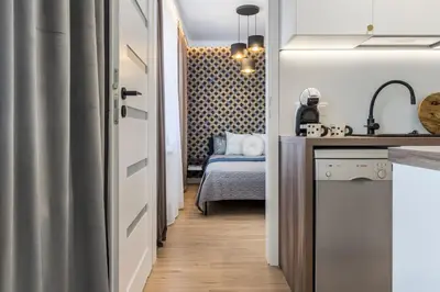 Łóżko lub łóżka w pokoju w obiekcie Nowolipie Blue Apartament