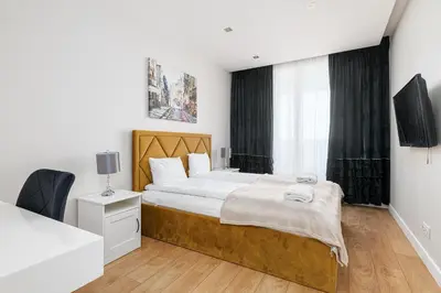 Łóżko lub łóżka w pokoju w obiekcie RentPlanet - Apartament Rodziewiczówny