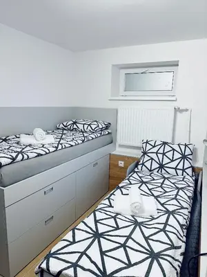 Łóżko lub łóżka w pokoju w obiekcie Studio WIKTORIA