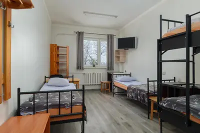Łóżko lub łóżka w pokoju w obiekcie Hostel Pracowniczy za FSO