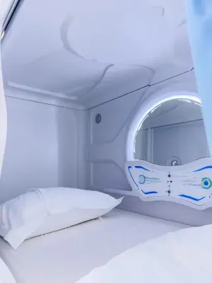 Łóżko lub łóżka w pokoju w obiekcie Boutique-Capsule Hostel