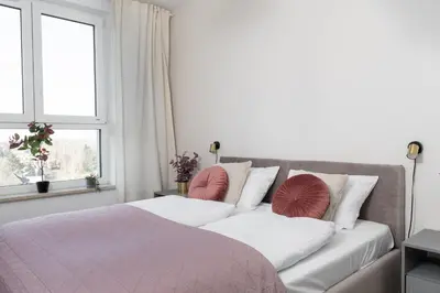 Łóżko lub łóżka w pokoju w obiekcie Blushline Apartment Wiktoryn AC Balcony