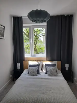 Łóżko lub łóżka w pokoju w obiekcie Bonifacy Apartment