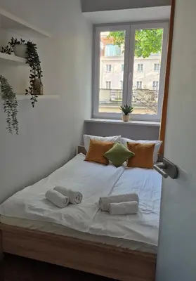 Łóżko lub łóżka w pokoju w obiekcie Copernicus Old Town Apartment
