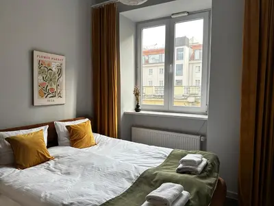 Łóżko lub łóżka w pokoju w obiekcie Copernicus Old Town Apartment