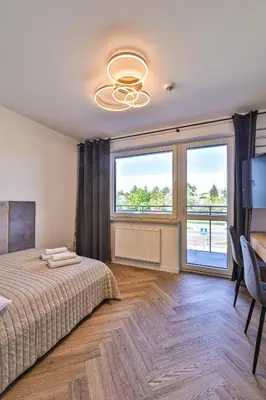 Łóżko lub łóżka w pokoju w obiekcie PIleckiego 59 Studio z Balkonem Bezpłatny Parking By Perfect Apart