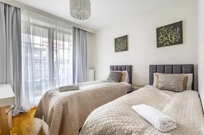 Łóżko lub łóżka w pokoju w obiekcie Apartament Leszczyńska, Powiśle