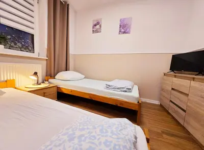 Łóżko lub łóżka w pokoju w obiekcie Rent Warszawa Ursynów