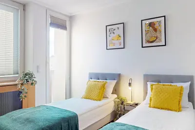 Łóżko lub łóżka w pokoju w obiekcie Mango Apartment City Center Wspolna