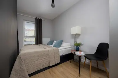 Łóżko lub łóżka w pokoju w obiekcie Unique Bright Studio for 4 People Remote Work & Balcony Close to PGE by Noclegi Renters