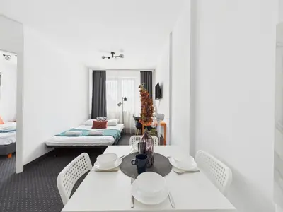 Łóżko lub łóżka w pokoju w obiekcie Galopu 7 SuperApart - Blisko lotniska i toru Służewiec