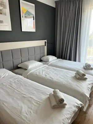 Łóżko lub łóżka w pokoju w obiekcie Warsoliv Apartamenty