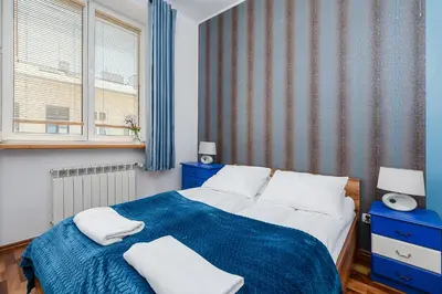 Łóżko lub łóżka w pokoju w obiekcie ShortStayPoland Ordynacka B139