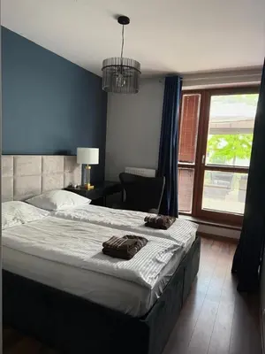 Łóżko lub łóżka w pokoju w obiekcie Apartament 3 pokojowy Miasteczko Wilanów 77m2