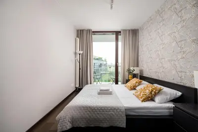 Łóżko lub łóżka w pokoju w obiekcie Ochota Prime Loft Apartment by BookingHost