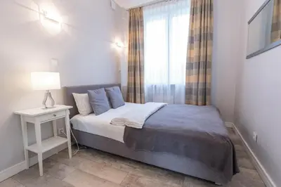 Łóżko lub łóżka w pokoju w obiekcie Rental Apartments Krochmalna