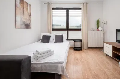Łóżko lub łóżka w pokoju w obiekcie Wola Parkside Comfy Studio by BookingHost