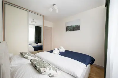 Łóżko lub łóżka w pokoju w obiekcie Wrzeciono Comfortline Apartment by BookingHost