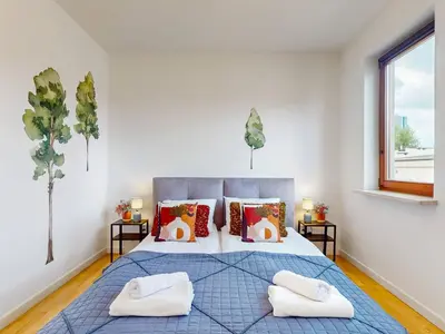 Łóżko lub łóżka w pokoju w obiekcie Urban Jungle Apartment With AC Praga Poludnie