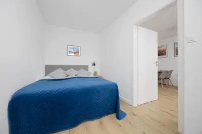 Łóżko lub łóżka w pokoju w obiekcie Łucka Bright Apartment with Parking in Warsaw by Noclegi Renters