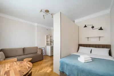 Łóżko lub łóżka w pokoju w obiekcie Widok Warsaw City Apartment by BookingHost