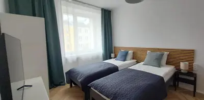 Łóżko lub łóżka w pokoju w obiekcie Klemens Apartment
