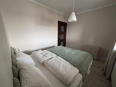 Łóżko lub łóżka w pokoju w obiekcie Oliwkowy Apartament Hennela