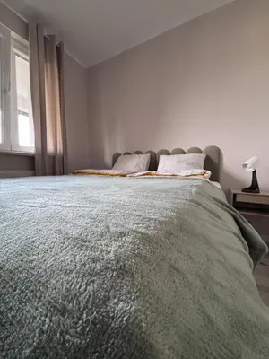 Łóżko lub łóżka w pokoju w obiekcie Oliwkowy Apartament Hennela