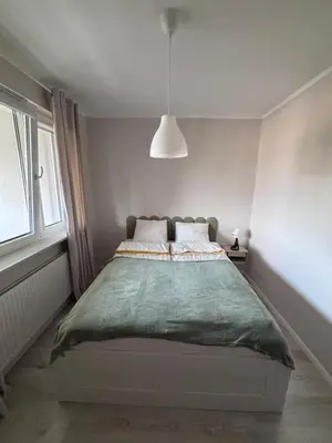 Łóżko lub łóżka w pokoju w obiekcie Oliwkowy Apartament Hennela