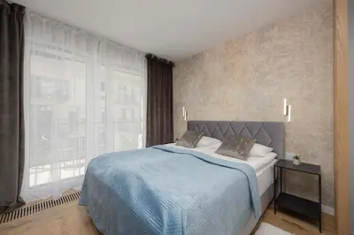 Łóżko lub łóżka w pokoju w obiekcie Komfortowe Rodzinne Studio Okrzei Warszawa by Noclegi Renters