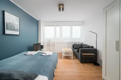 Łóżko lub łóżka w pokoju w obiekcie Vistula Corner Studio by BookingHost