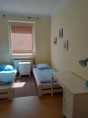 Łóżko lub łóżka w pokoju w obiekcie Dom Jasińskiego