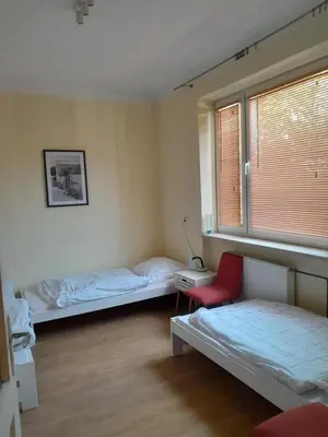 Łóżko lub łóżka w pokoju w obiekcie Dom Jasińskiego