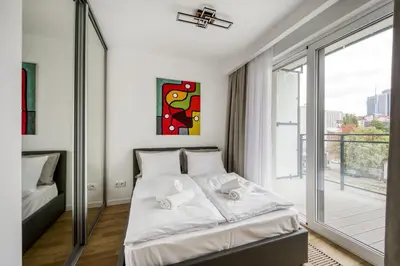 Łóżko lub łóżka w pokoju w obiekcie New Garden Apartments