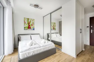 Łóżko lub łóżka w pokoju w obiekcie New Garden Apartments