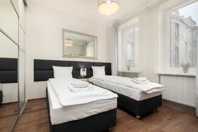 Łóżko lub łóżka w pokoju w obiekcie Apartament Chmielna by Your Freedom