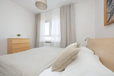 Łóżko lub łóżka w pokoju w obiekcie Family Apartment with 2 Bedrooms on the 16th Floor in Warsaw by Noclegi Renters