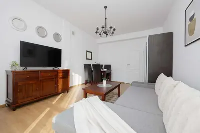 Telewizja i/lub zestaw kina domowego w obiekcie Bright Apartment in Muranów Close to the Old Town by Noclegi Renters