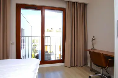 Łóżko lub łóżka w pokoju w obiekcie Moko RAR Apartments