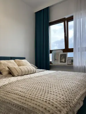 Łóżko lub łóżka w pokoju w obiekcie Wilanów Residence - Two-Room Apartment