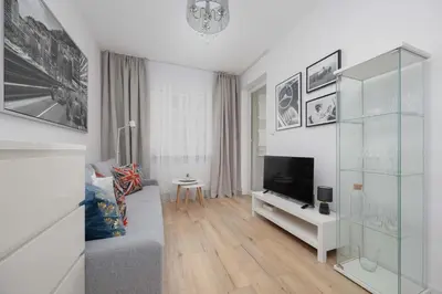 Telewizja i/lub zestaw kina domowego w obiekcie Bright Grey Apartment in Warsaw with Balcony by Noclegi Renters
