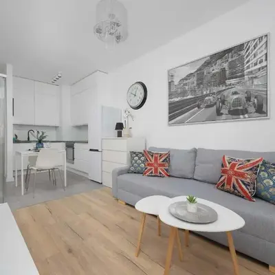 Bright Grey Apartment in Warsaw with Balcony by Noclegi Renters