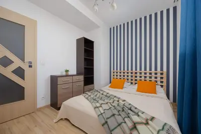 Łóżko lub łóżka w pokoju w obiekcie Grey Apartment in Warsaw with City View and Balcony by Noclegi Renters